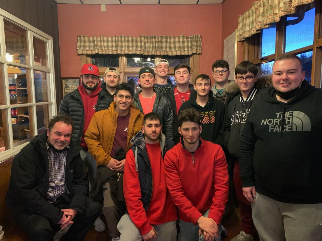 A group of Sigma-Epsilon brothers gathered indoors.