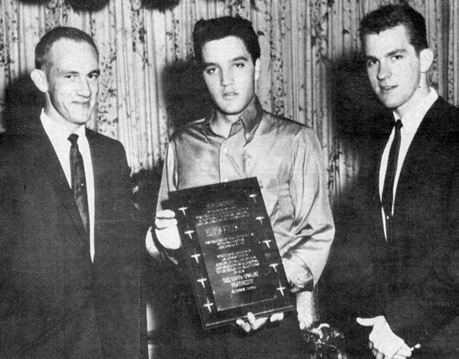 Elvis Presley receiving a plaque