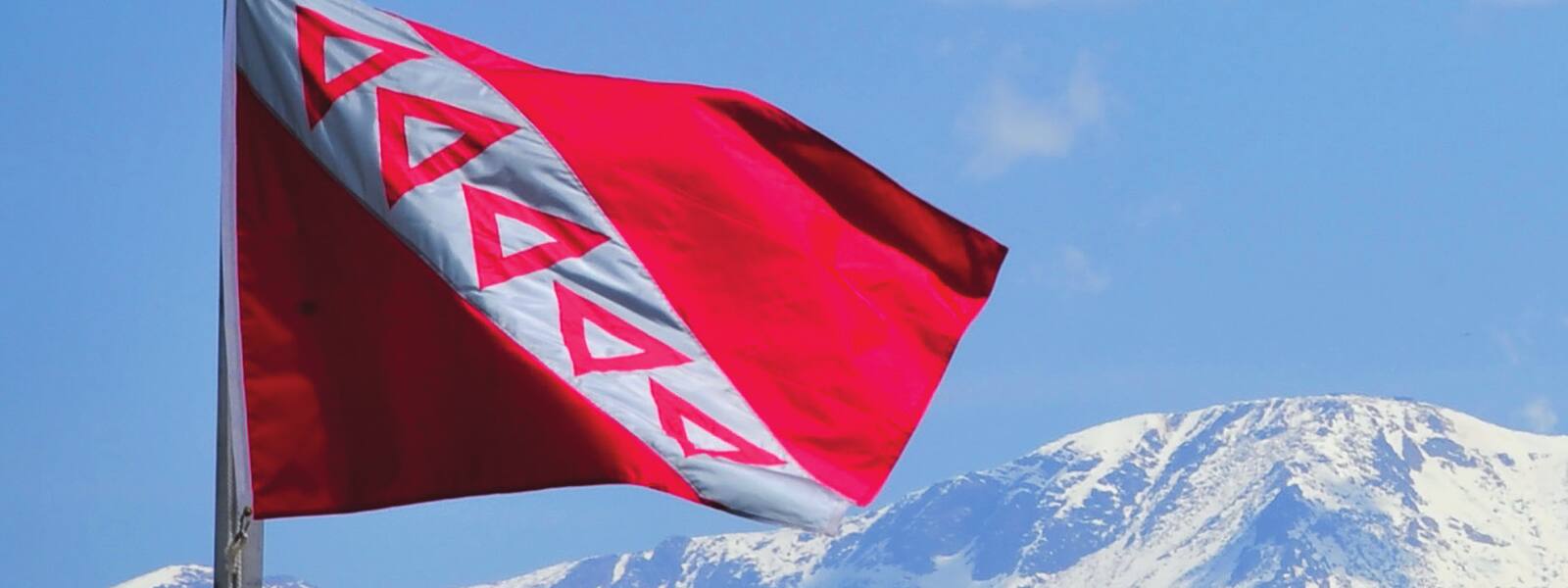 The TKE flag flying against a blue sky