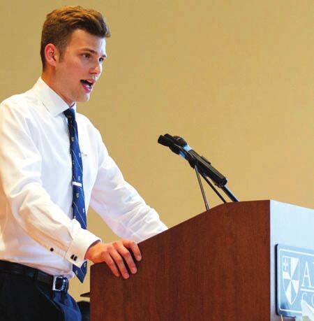 A Teke speaking at a podium